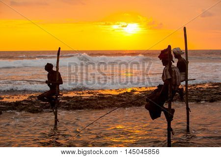 AHANGAMA - NOVEMBER 27 : Still fisherman's fishing fish at sunset on November 27 2015 in Ahangama Sri Lanka