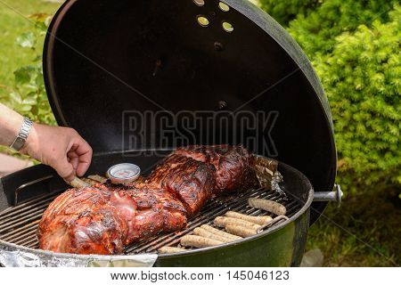 succulent meats and sausages on kettle grill
