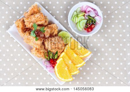 Fried tofu nuggets with minced shrimp and pork on gray background.