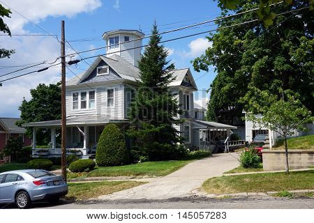 PETOSKEY, MICHIGAN / UNITED STATES - AUGUST 5, 2015: A Victorian mansion, with a wraparound porch and an observation tower, on Lake Street near downtown Petoskey.