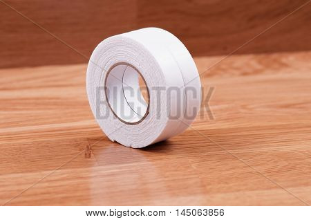 Pair roll's of double sided tape on wooden background