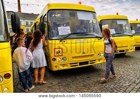 Students considering new school buses during their transmission to the representatives of educational institutions in four districts of the Transcarpathian region Uzhgorod August 30 2016
