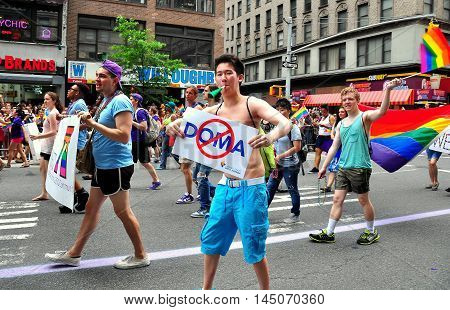 New York City - June 29 2013: Asian marcher carrying sign saying no to DOMA at the 2013 Gay Pride Parade on Fifth Avenue *