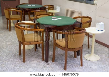 image of tables with green cloth for card games
