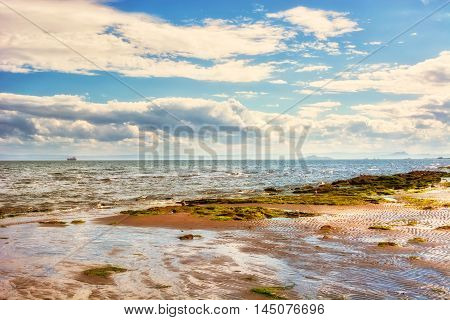 Coastal landscape at low tide in Scotland UK. The town of Kirkcaldy