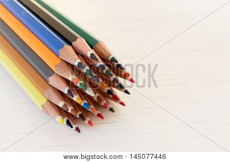Sharp colorful crayons grouped as a bunch