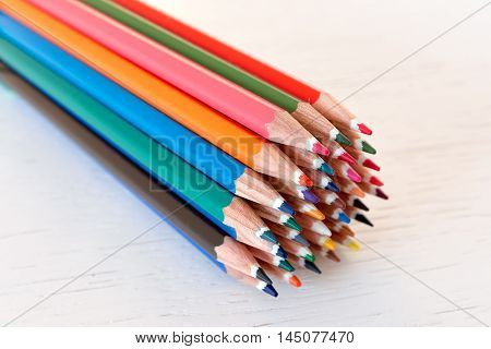 Sharp colorful crayons grouped as a bunch