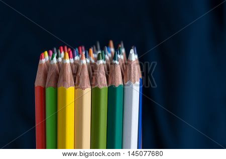 Sharp colorful crayons grouped as a bunch