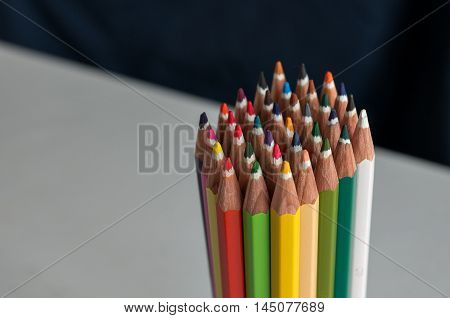 Sharp colorful crayons grouped as a bunch