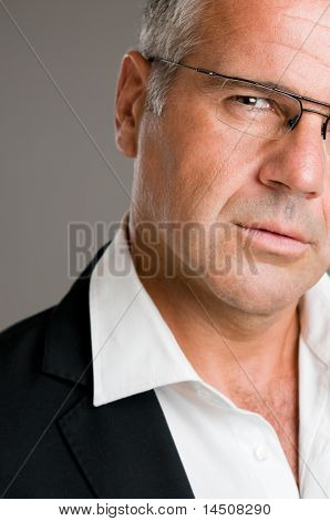 Closeup ritratto di pensoso uomo maturo con gli occhiali