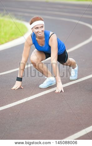 Young Happy Smiling Caucasian Female Athlete Training on Sport Venue Outdoors.Vertical Image