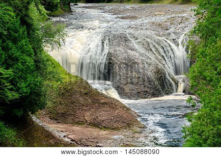 Potawatomi Falls located on the Black River Scenic Byway in the Upper Peninsula of Michigan flows over sandstone rocks