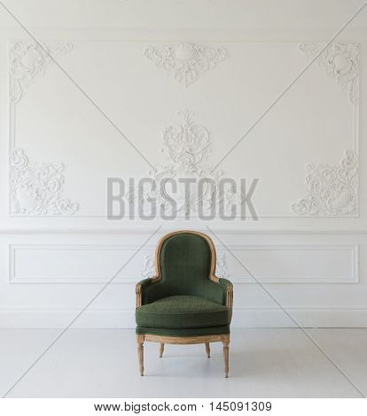 Antique green armchair fretwork wall on backround