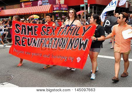 New York City - June 29 2013: Same Sex Family Reunification group marching with their banner in the 2013 Gay Pride Parade on Fifth Avenue