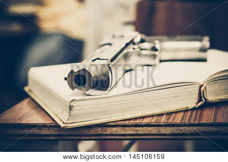 A gun on a textbook / gun allowed in some US university concept