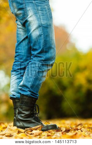 Nature outdoor foliage relax concept. Man in black boots. Male in leather footwear jeans trousers standing outside.