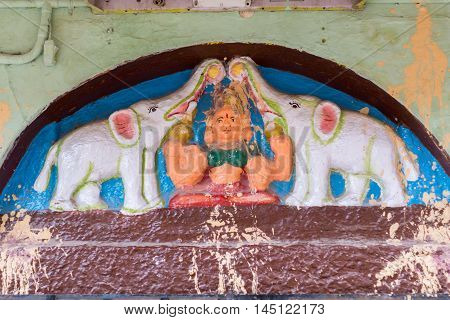 Madurai India - October 19 2013: Mural on the outside wall of Meenakshi Temple shows Devi Lakshmi showered by two white elephants.