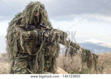 Ghillie suit sniper scope and rifle camouflage