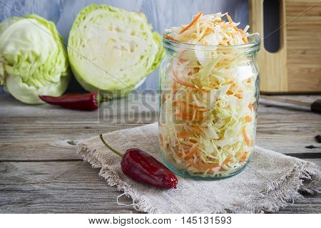 Pickled cabbage with carrots and red hot peppers selective focuc