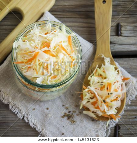 Pickled cabbage with carrots and red hot peppers selective focuc