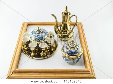 Gold jug Tea glass benjarong in frame on white background