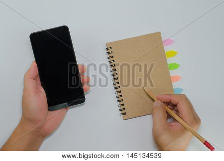 Catch smartphone recycled paper notebook front cover on white background