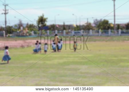 Student Kindergarten. Blur blurred student Kindergarten running on grass in school Teachers have run lead.