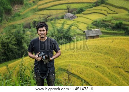 Portrait of Asian traditional handsome men Rice fields on terraced Background at Rice fields prepare the harvest at Northwest Vietnam
