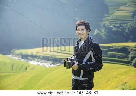 Portrait of Asian traditional handsome men Rice fields on terraced Background at Rice fields prepare the harvest at Northwest Vietnam