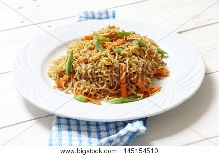 Fried instant noodle with green bean, egg and carrot