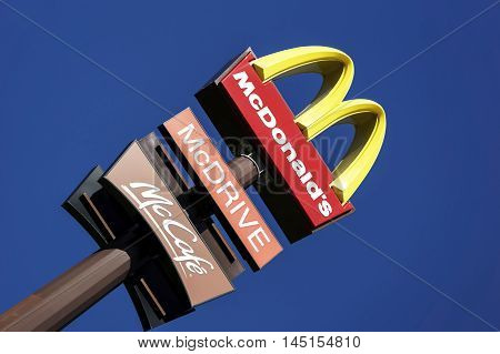 BOLOGNA, ITALY - AUGUST 24 2016 - Editorial: the mcdonalds advertising sign above a pylon in the blue sky