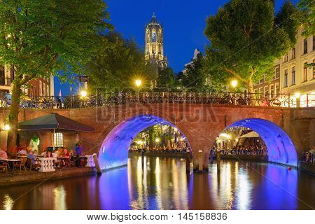 Dom Tower and canal in the night colorful illuminations in the blue hour, Utrecht, Netherlands