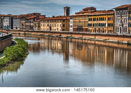 Pisa lungarno under a dramatic sky Italy