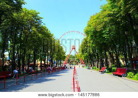 Kharkiv / Ukraine. 07 August 2016: view to ferris wheel and people walk in Gorky park in Kharkiv. 07 August 2016 in Kharkiv / Ukraine.