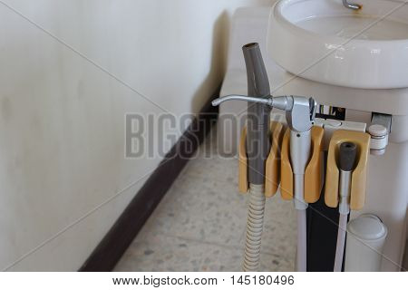 Metallic dentist tool. in  Clinic specialized equipment to treat all types of dental diseases in the office:Select focus with shallow depth of field.