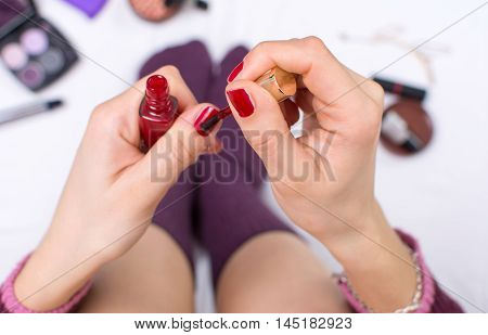 Girl Applying Nail Polish In Bed