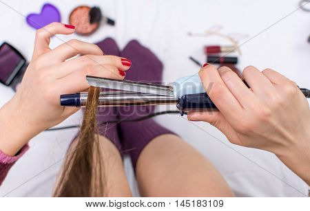 Point Of View Of Woman Using Curling Iron