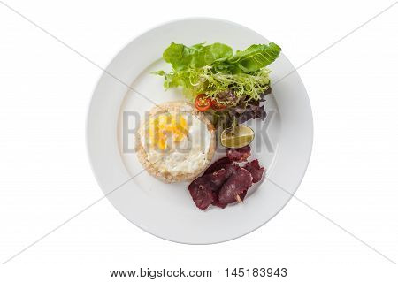 Top view of Modern Thai style fried rice with salted beef and fried egg in ceramic dish isolated on white background