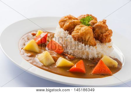Japanese cuisine rice with deep fried chicken and curry sauce with potatoes and carrots in ceramic dish
