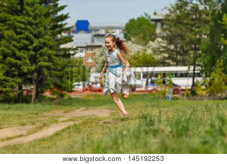 Girl laughing and running at city park