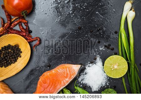 Fresh Raw Salmon Filet With Spicy Herbs On Black Plate
