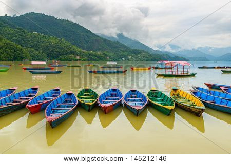 Colorful small boats on Phewa Lake in Pokhara, Nepal