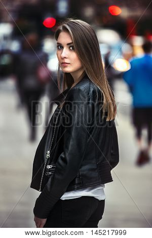 beautiful young woman walking on the crowdy street