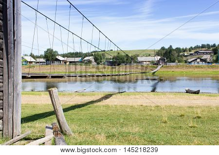 Rural Landscape At Summer With Suspension Bridge