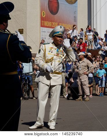 MOSCOW, RUSSIA - August 27, 2016: Bandmaster of brass band from Kazakhstan asks the audience what musical composition to execute. Festival of military orchestras 