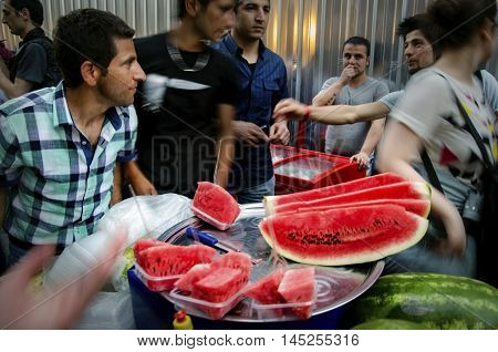 Istanbul Turkey - May 05 2013: Istanbul street sliced watermelon seller Istanbul street sliced watermelon seller a slice of watermelon buyers insanlar in the street.