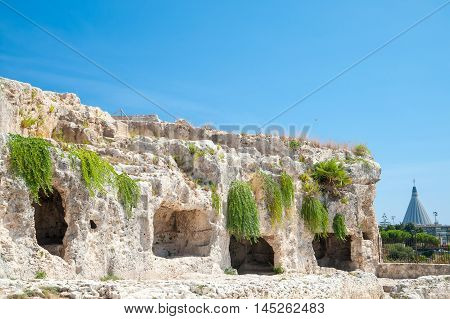 Section of the upper part of the greek theater in Syracuse with its typical rock cut tombs