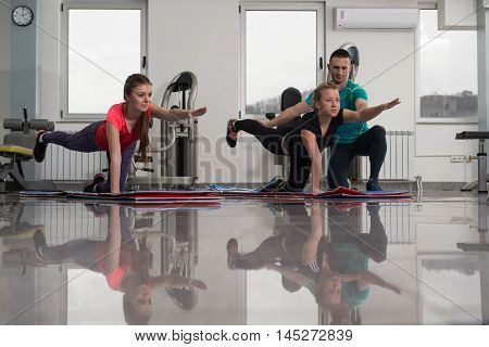 People Stretching During Fitness Class In Fitness Center