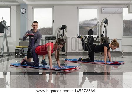 Group Of Sportive People In A Gym Training