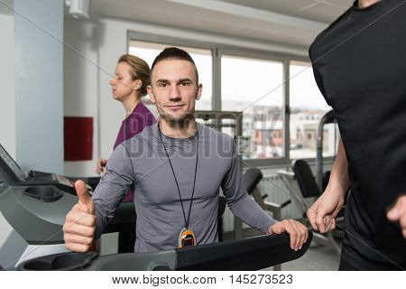 Personal Trainer Showing Ok Sign To Client